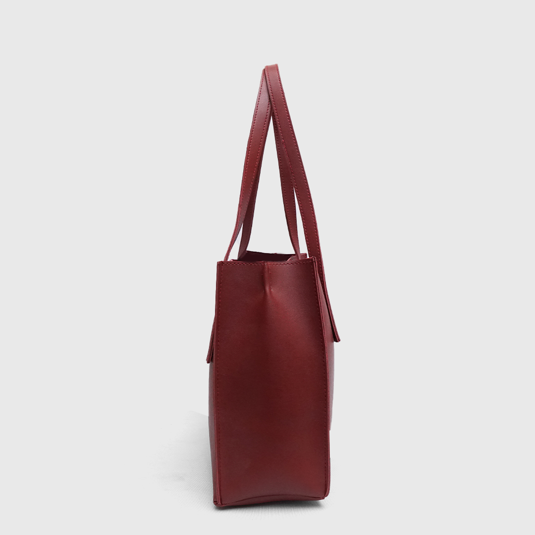 Side profile of structured maroon tote handbag