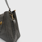 Close-up of crocodile embossed rexine handbag texture