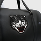Close-up of embroidered tiger patch on black travel duffle bag
