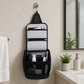 Compact black hanging toiletry bag with multiple compartments and durable build