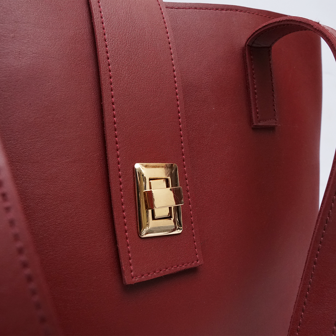 Interior compartments of maroon tote bag showing organized storage