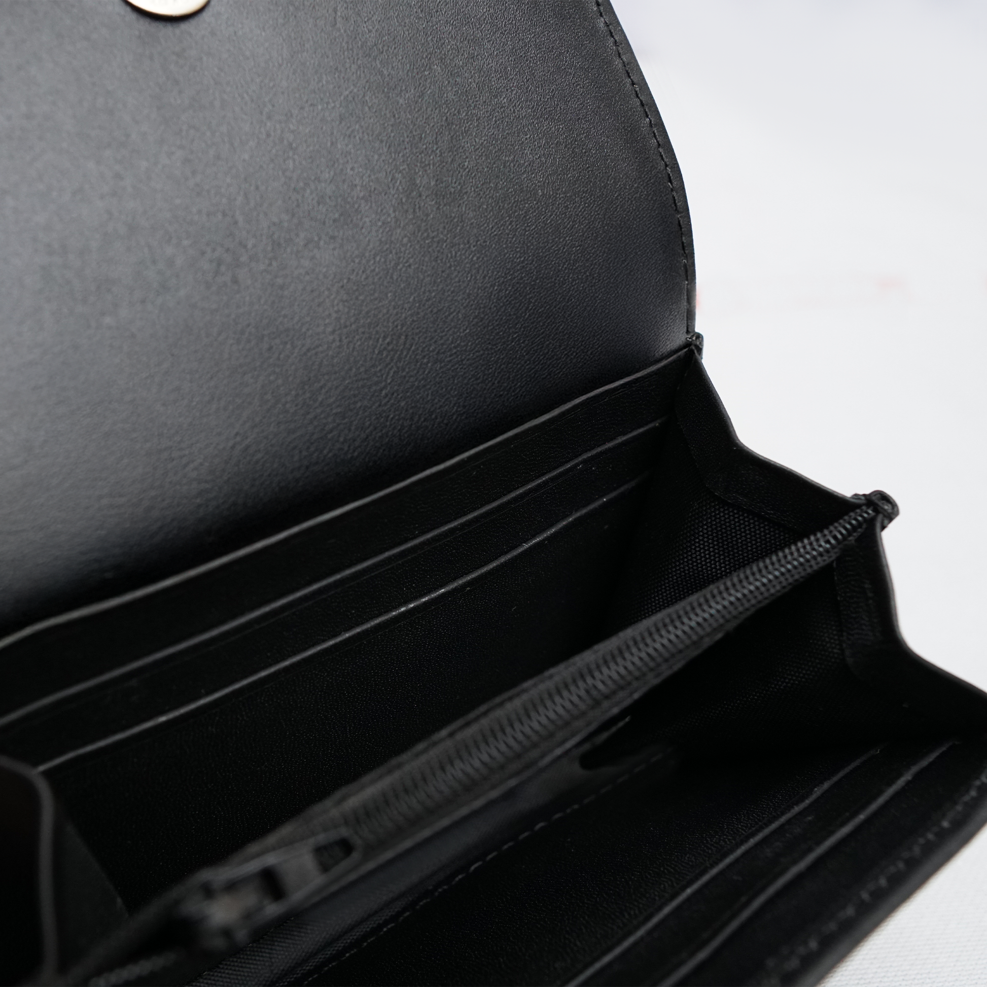 Minimal black wallet with card slots and zip pocket