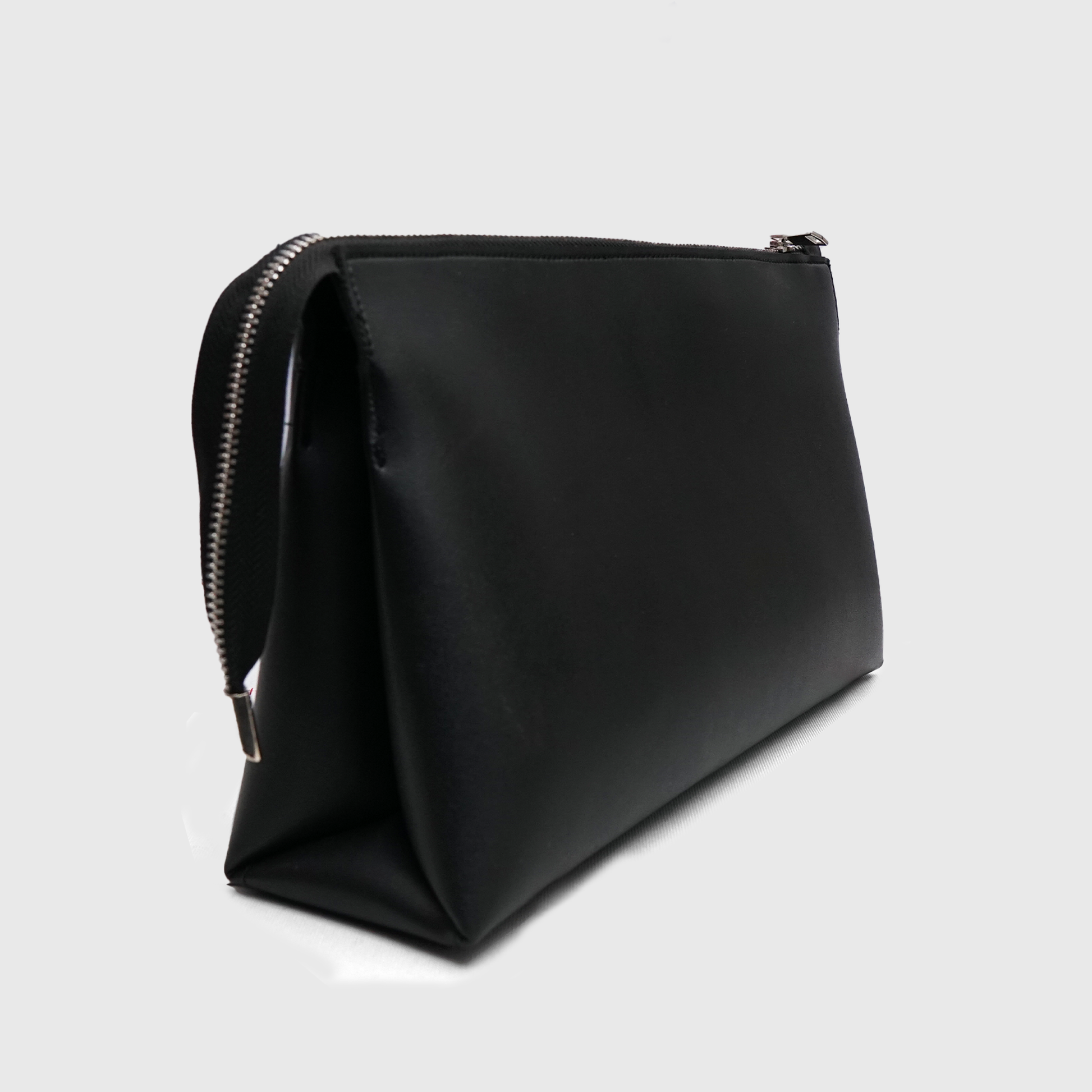 Premium NOIRÉ black clutch showcasing spacious structured design