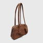 Side angle of mocha brown suede handbag