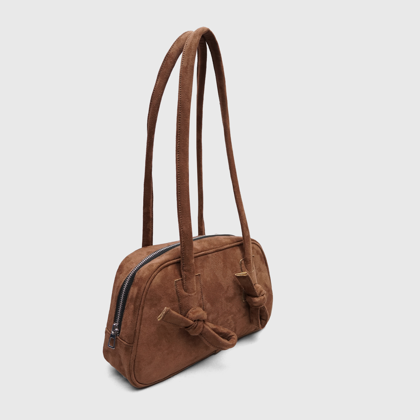 Side angle of mocha brown suede handbag