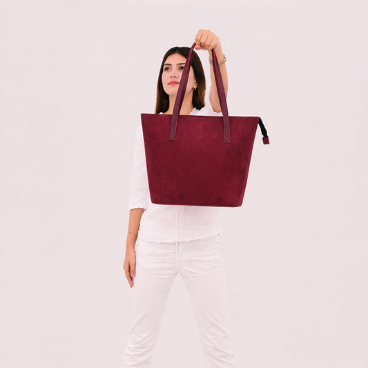 Side angle view of burgundy suede tote bag