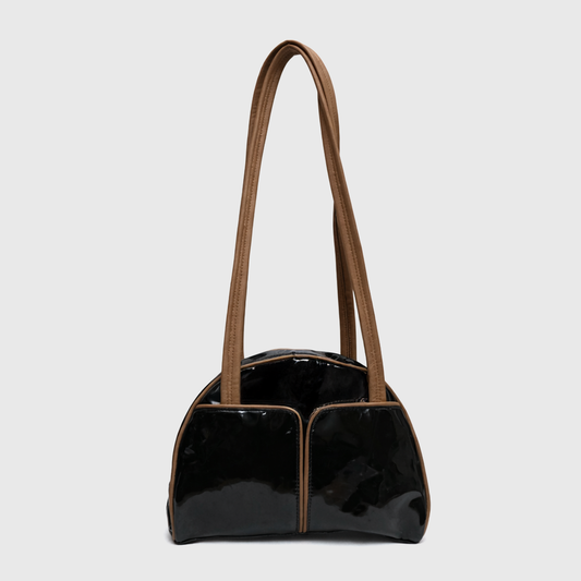 Side angle view of glossy black patent shoulder bag