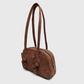 Side profile of brown suede shoulder handbag