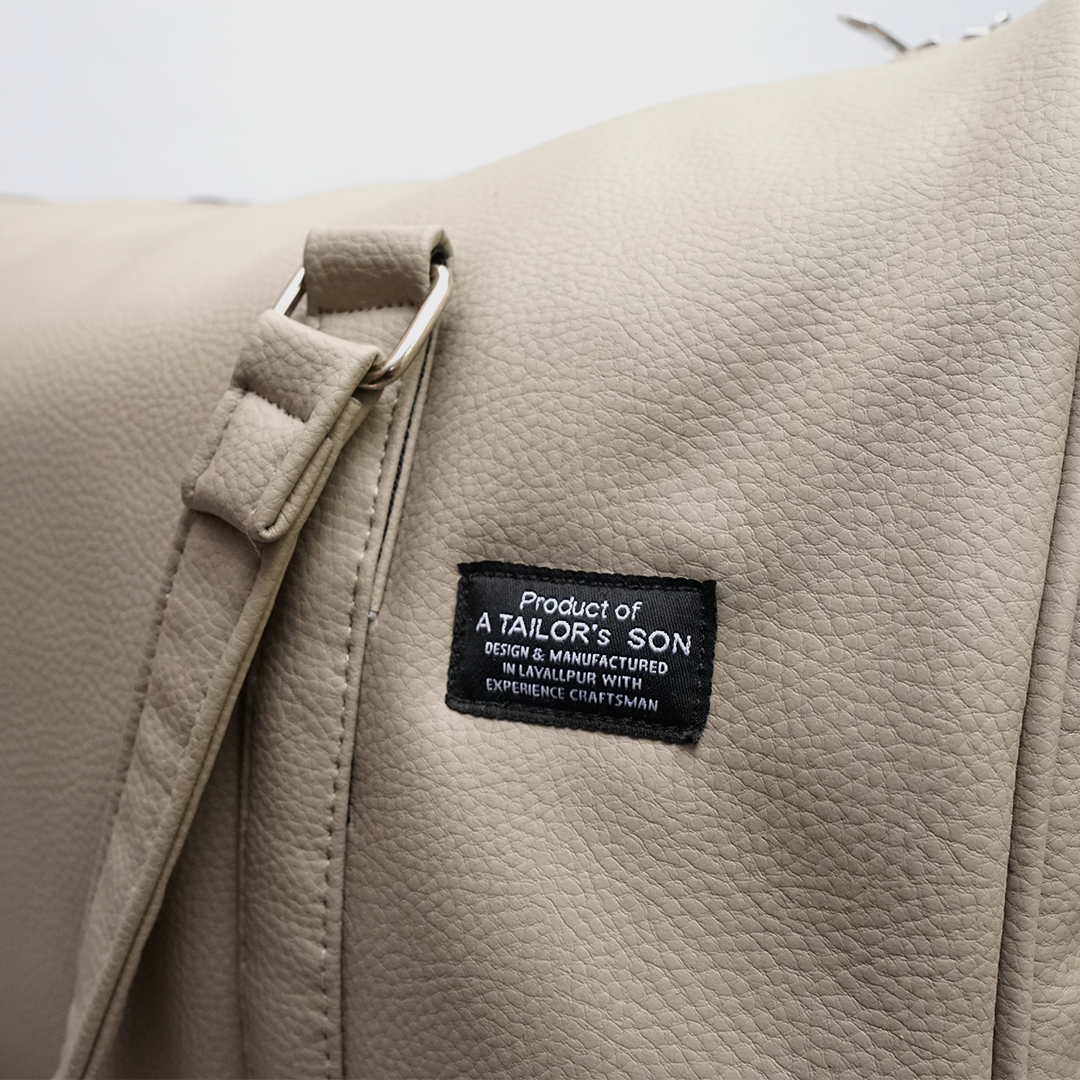 Side view of cream textured duffle bag