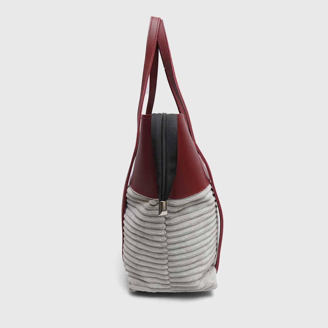 Side view of structured burgundy tote handbag