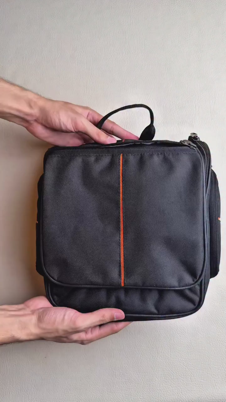 Hanging toiletry bag open with compartments and mesh pockets for organized travel essentials