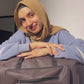 Brown faux leather baby bag with teddy bear embroidery, front zip pocket, spacious interior, and black shoulder handles for stylish daily use.